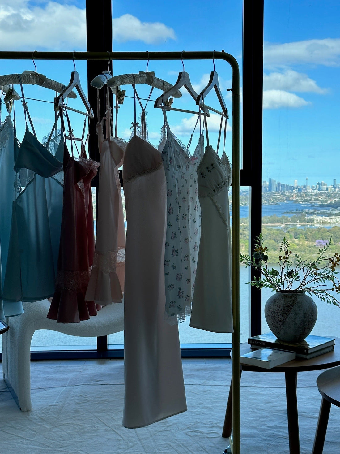 a photo of sleepwear hanging on the hanger with background of city and sky