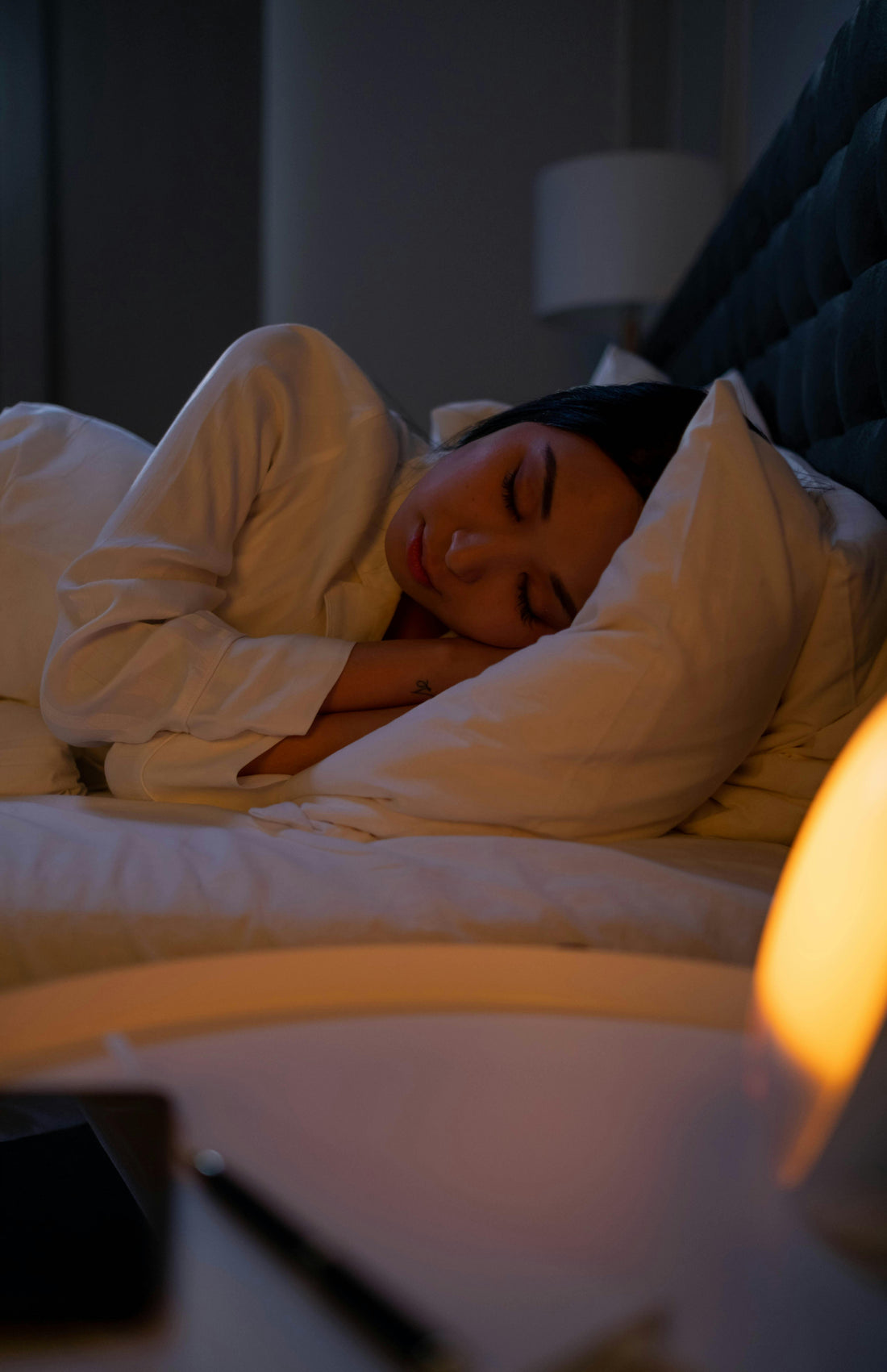 A woman sleeping on the bed with white sleepwear
