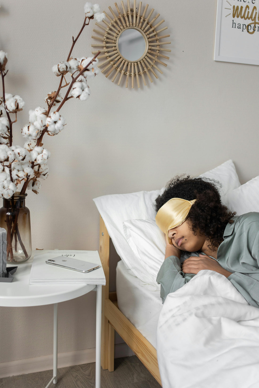a woman sleeping on bed with eye mask
